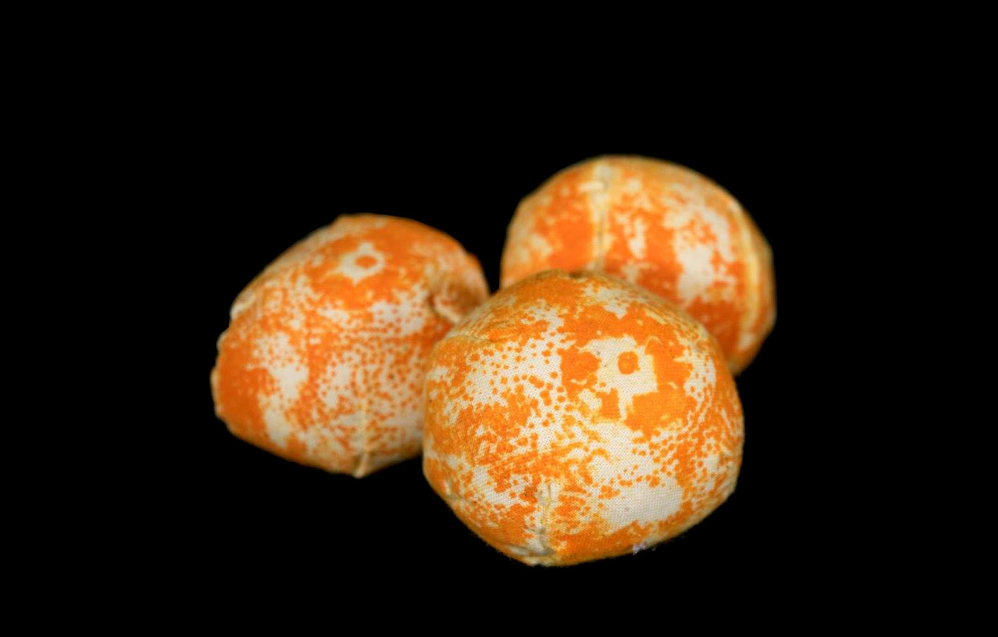 three fabric orbs printed with a clementine peel texture